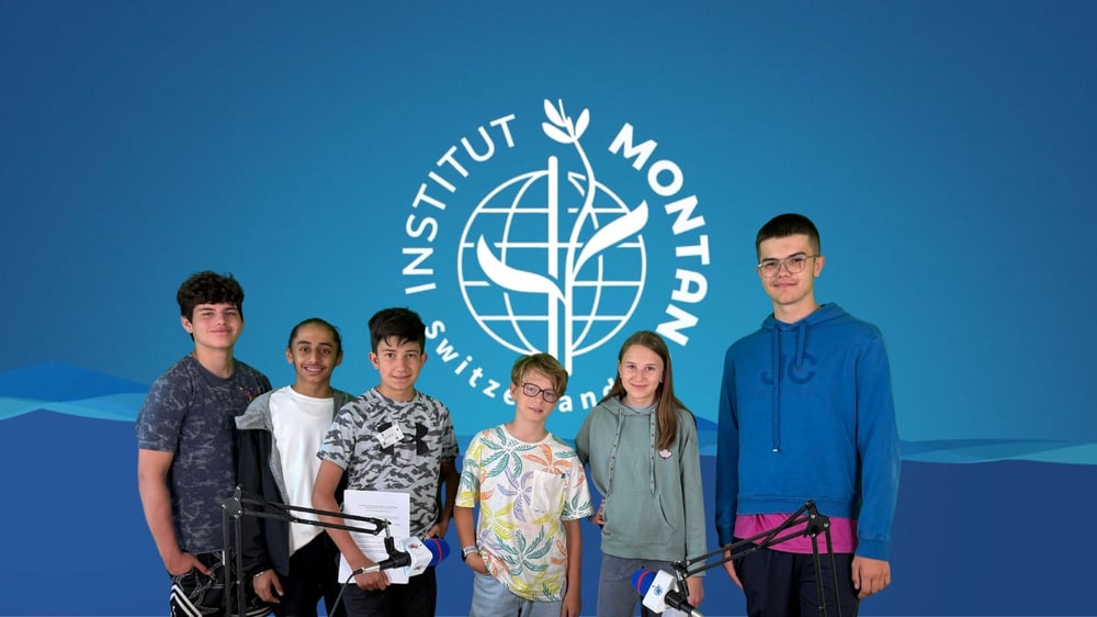 A group of kids in front of a blue backdrop.