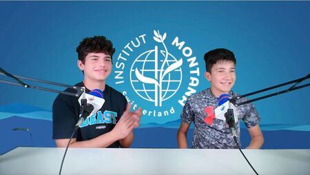 Two boys talk with mic