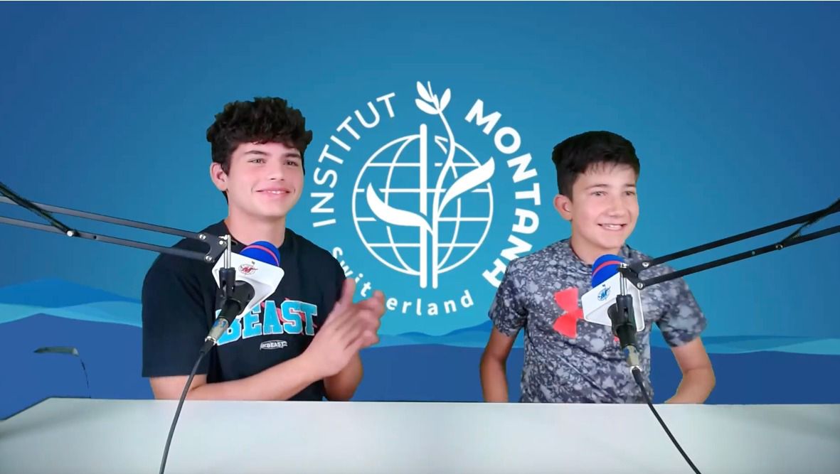 Two boys talk with mic