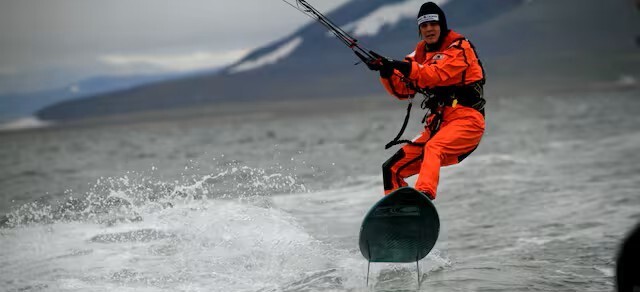 A young man kitesurfs