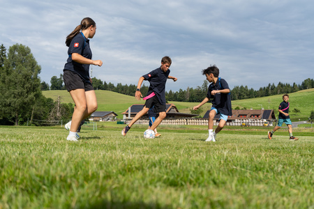 A group of kids playing football.