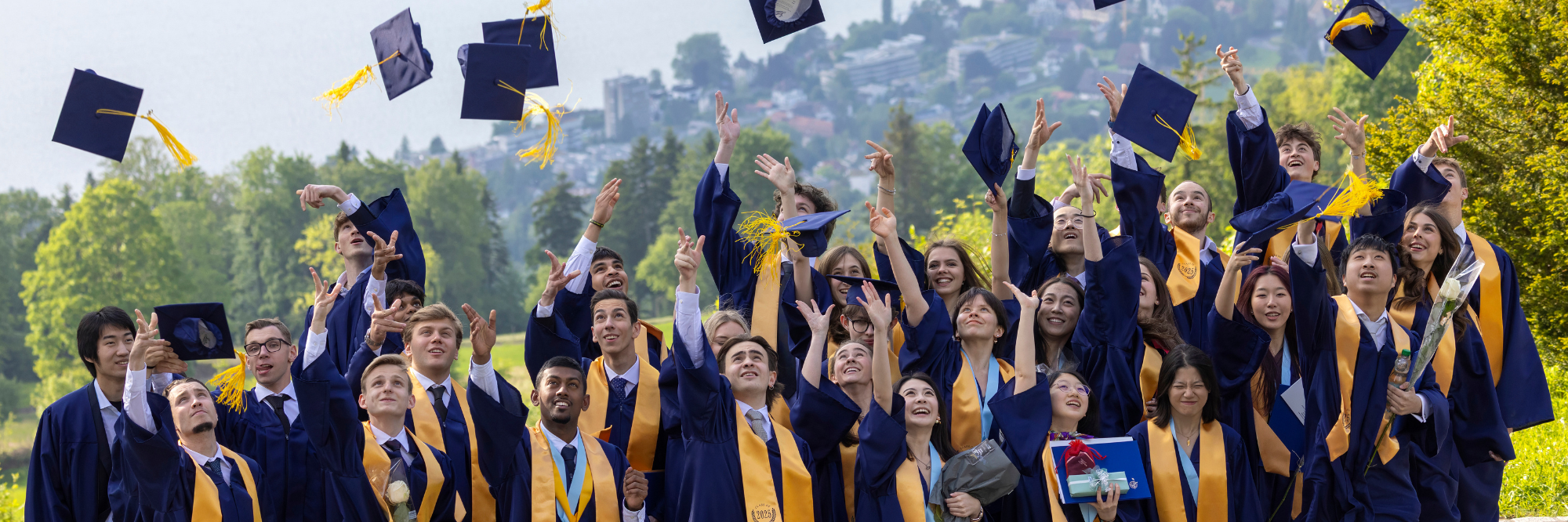 A group of students throw away their graduation caps.