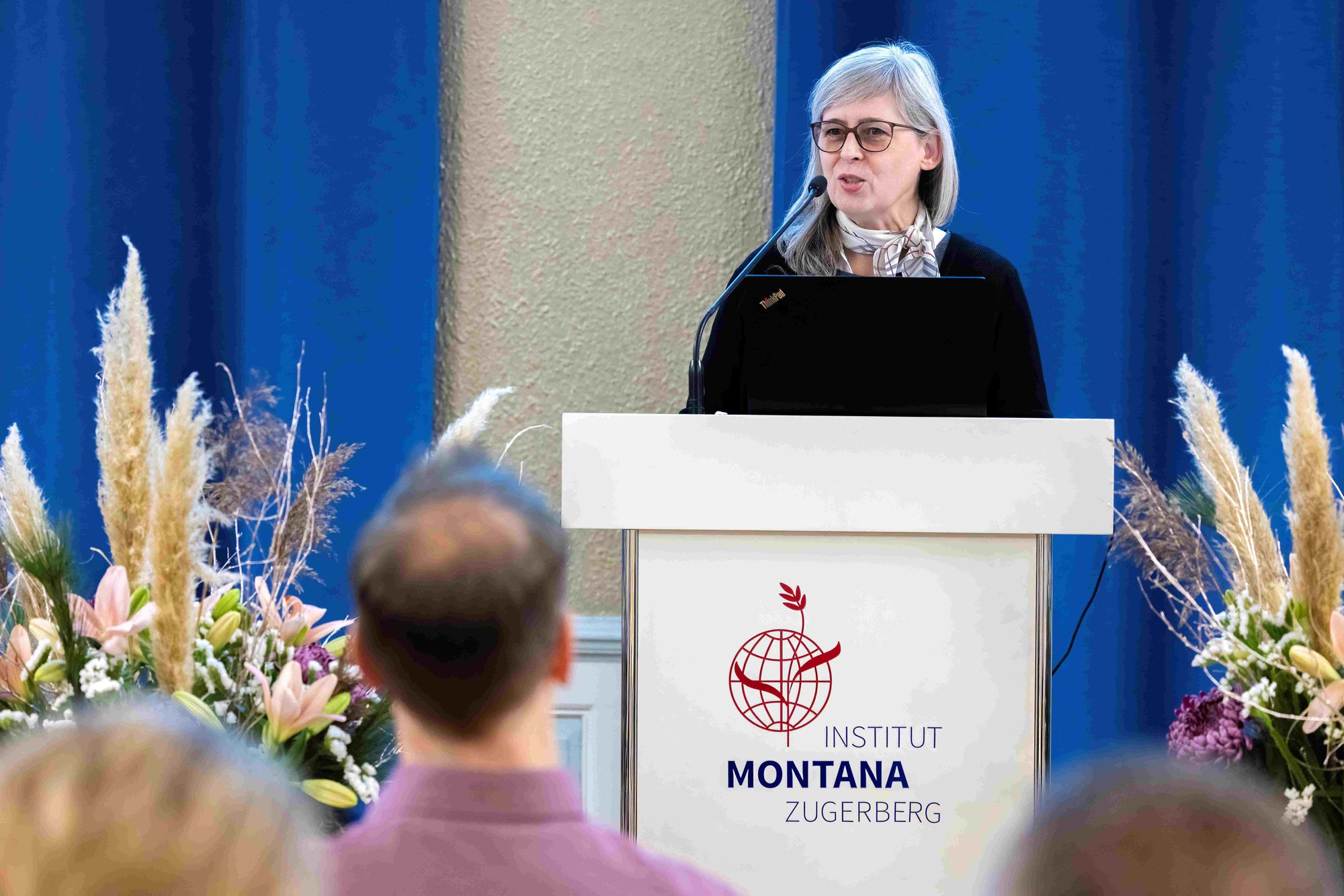 A lady talks at a podium. A lady talks at a podium.