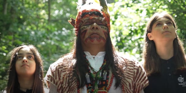A man in traditional clothing and two girls.