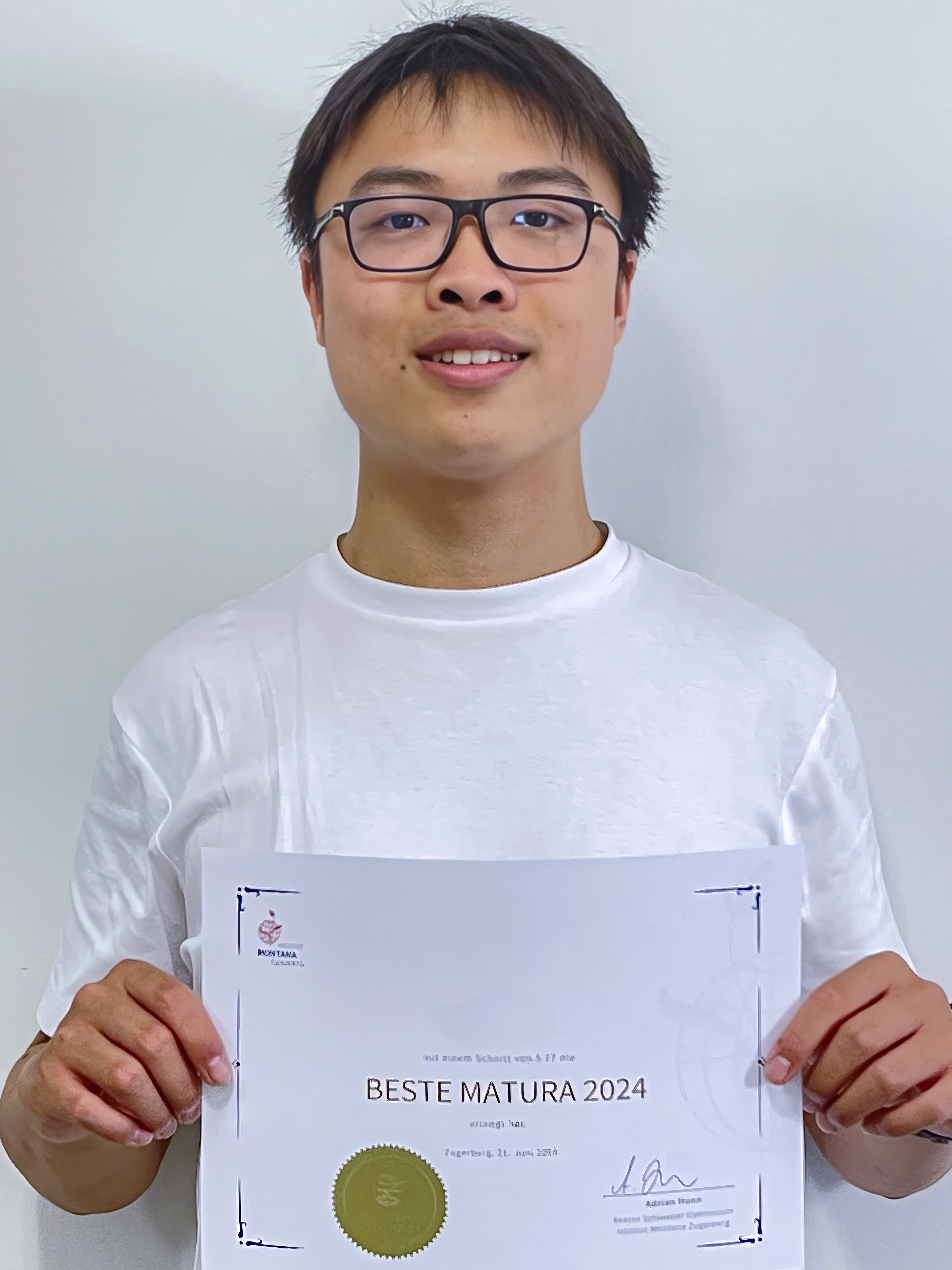 A man holding a certificate.